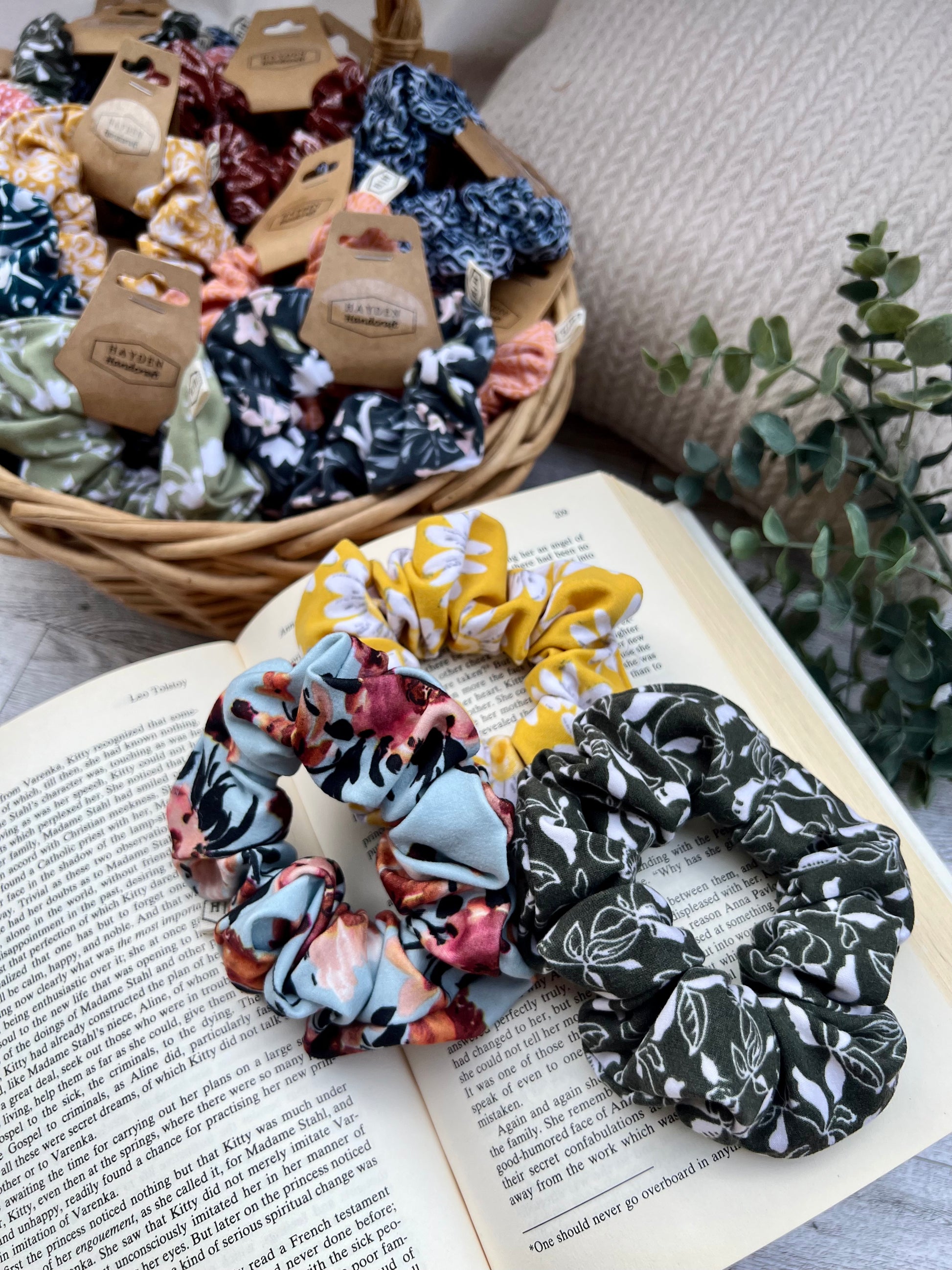 a variety of jersey hair scrunchies in floral and geometric patterns
